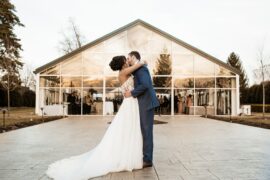 Bride and groom in front of Ritz Charles Garden Pavilion at sunset