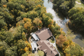 Aerial view of The Bluffs event venue including dense woods and the White River