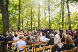 Outdoor Wedding Ceremony in the Woods with Light Shining Through the Trees